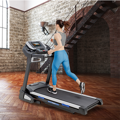 Woman with blonde hair running on the Xterra TRX5500 treadmill