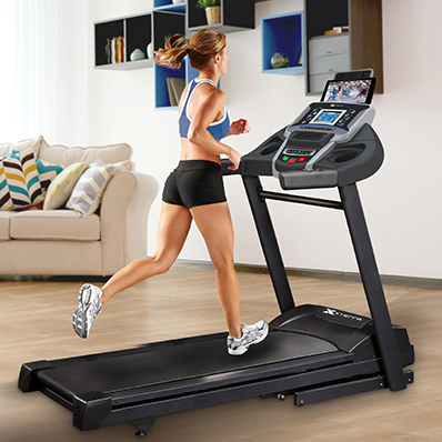 Woman with blonde hair running on the Xterra XT3000 treadmill