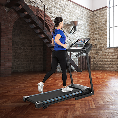 Woman with dark hair running on the Xterra TR150 treadmill